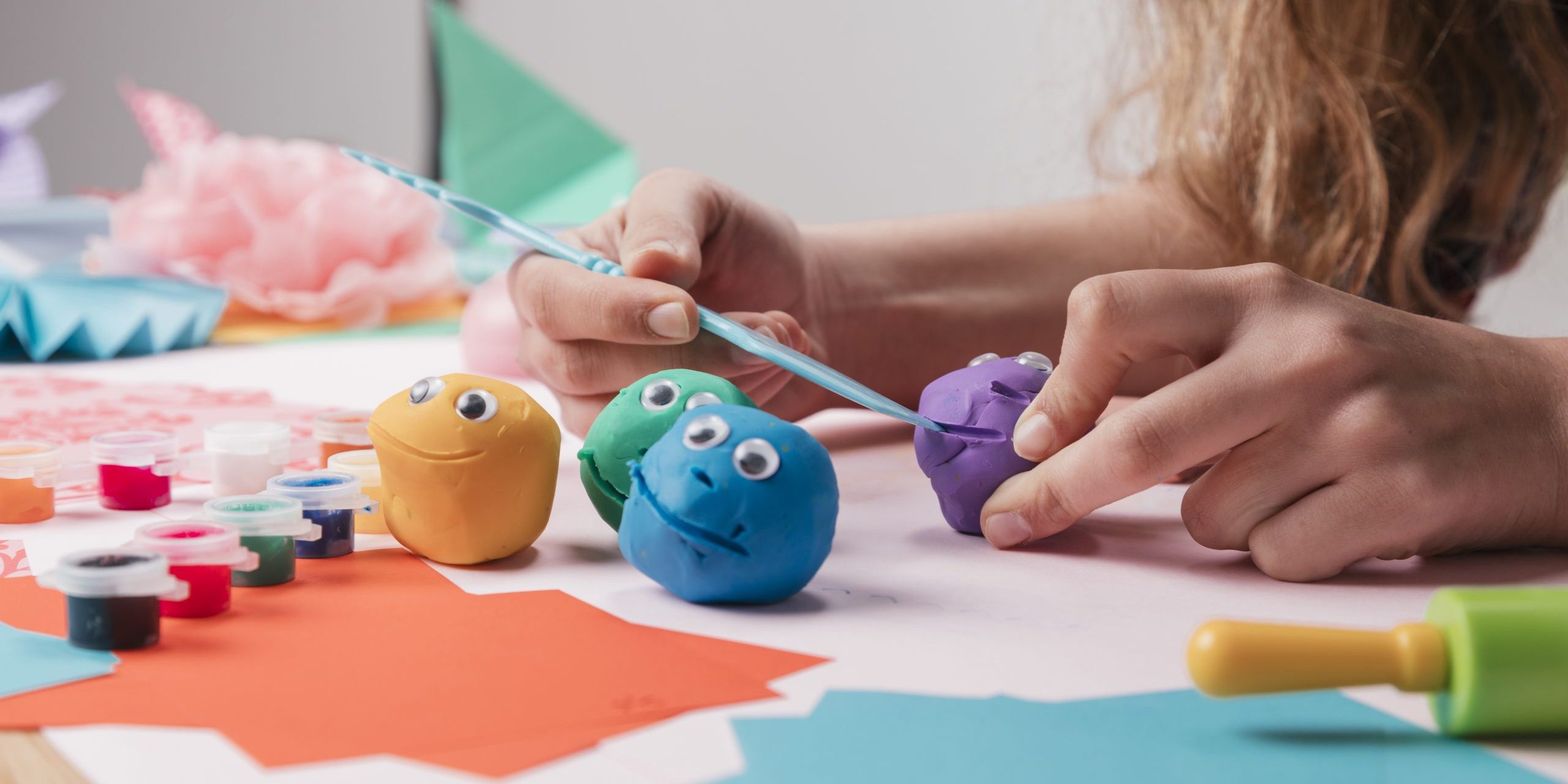 female-artist-hand-making-cartoon-faces-using-craft-equipment