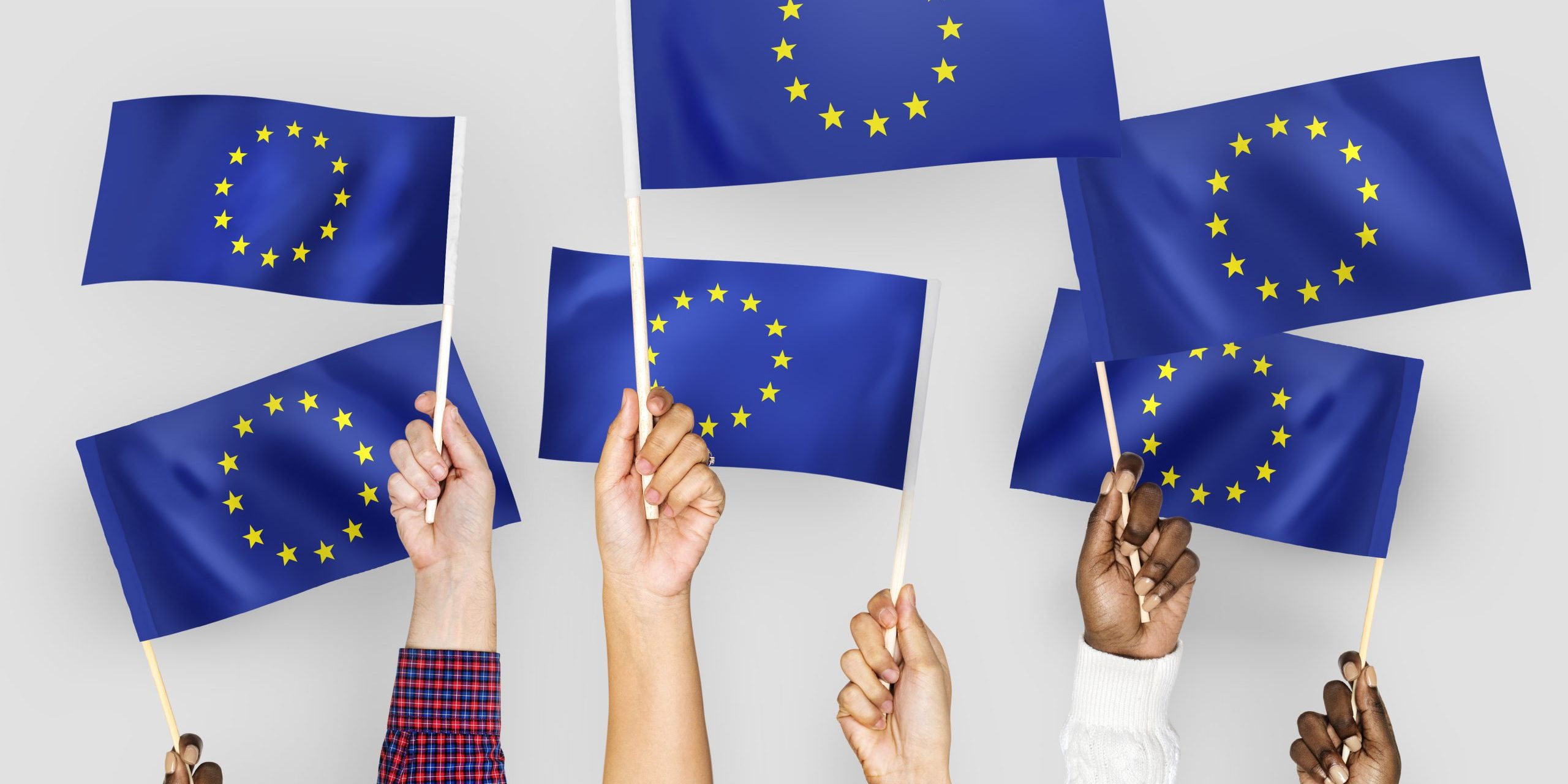 Hands waving flags of the EuropeanUnion